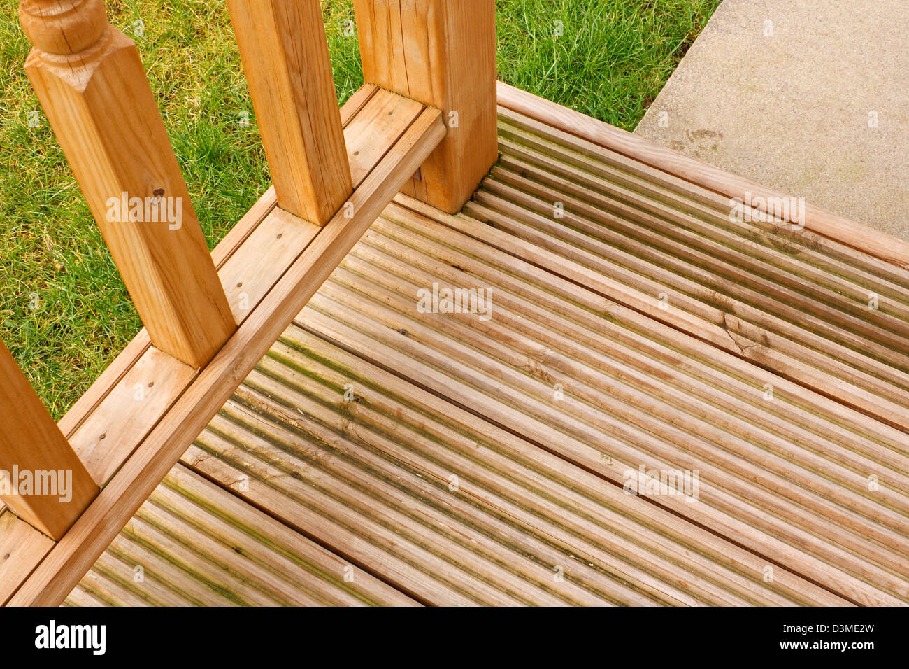 Corner profile of wooden garden decking a popular feature outside modern homes Stock Photo