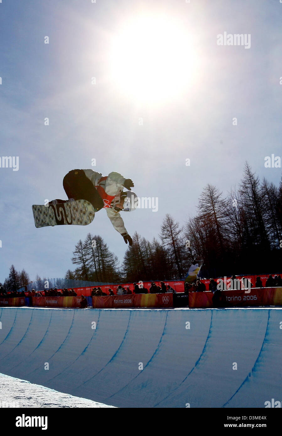 A snowboarder in action at the women's Olympic snowboard half pipe