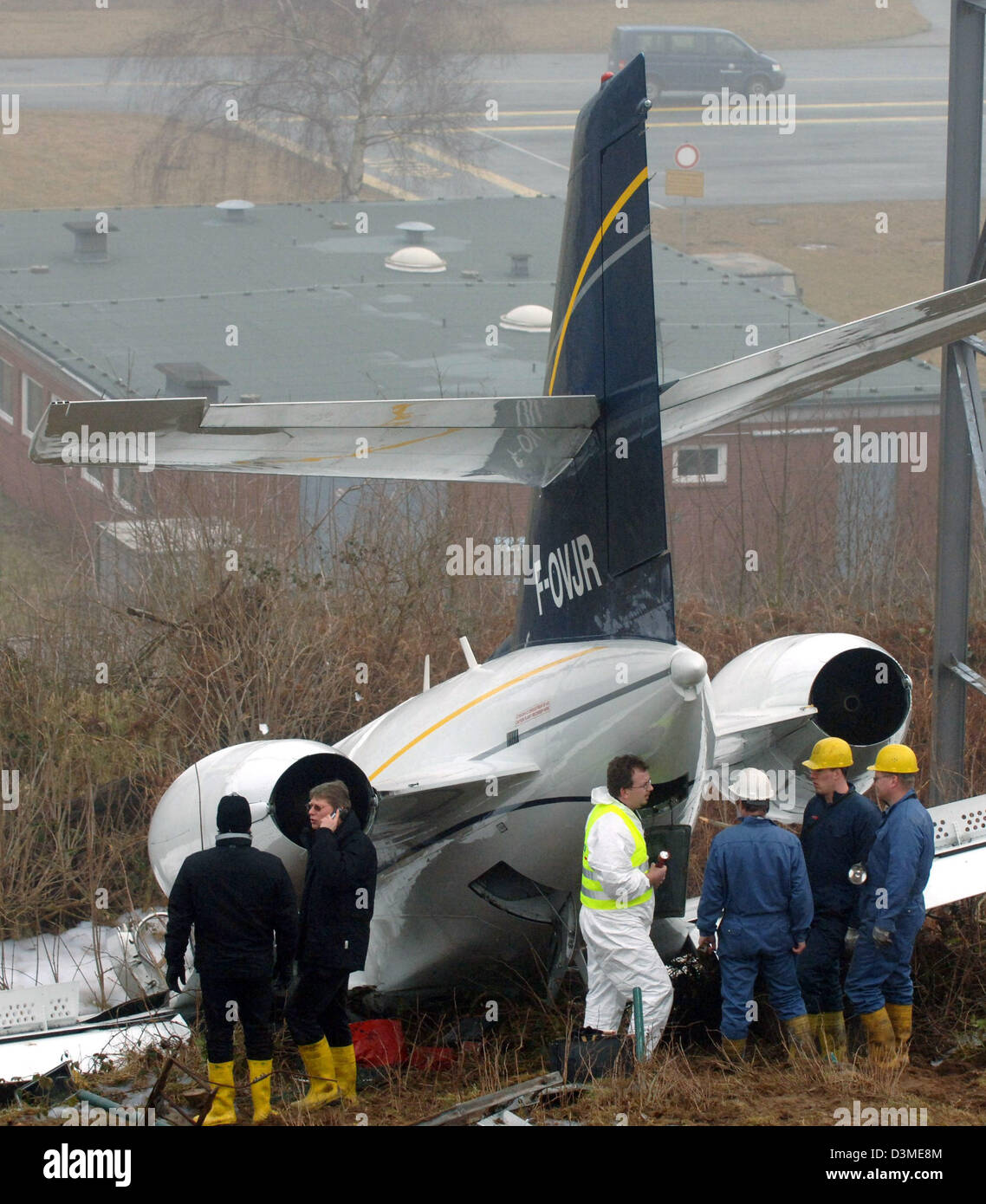 Experts of the Federal Office for Flight Investigation and police are in action at Kiel Airport, Germany, Thursday 16 February 2006. A plane with six people believed aboard made an emergency landing at a German airport Wednesday evening with a fire in its cockpit, police said. All aboard were injured but there was no immediate word on how badly. Initial reports had said 30 people w Stock Photo