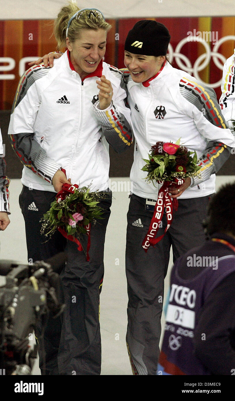 German speed skater Claudia Pechstein (R) and her team mate Anni Friesinger are very happy during the award ceremony in the Olympic speed skating rink Ligotto, Italy, 16 February 2006. The German stood up to Canada and claimed gold. Photo: Frank May Stock Photo