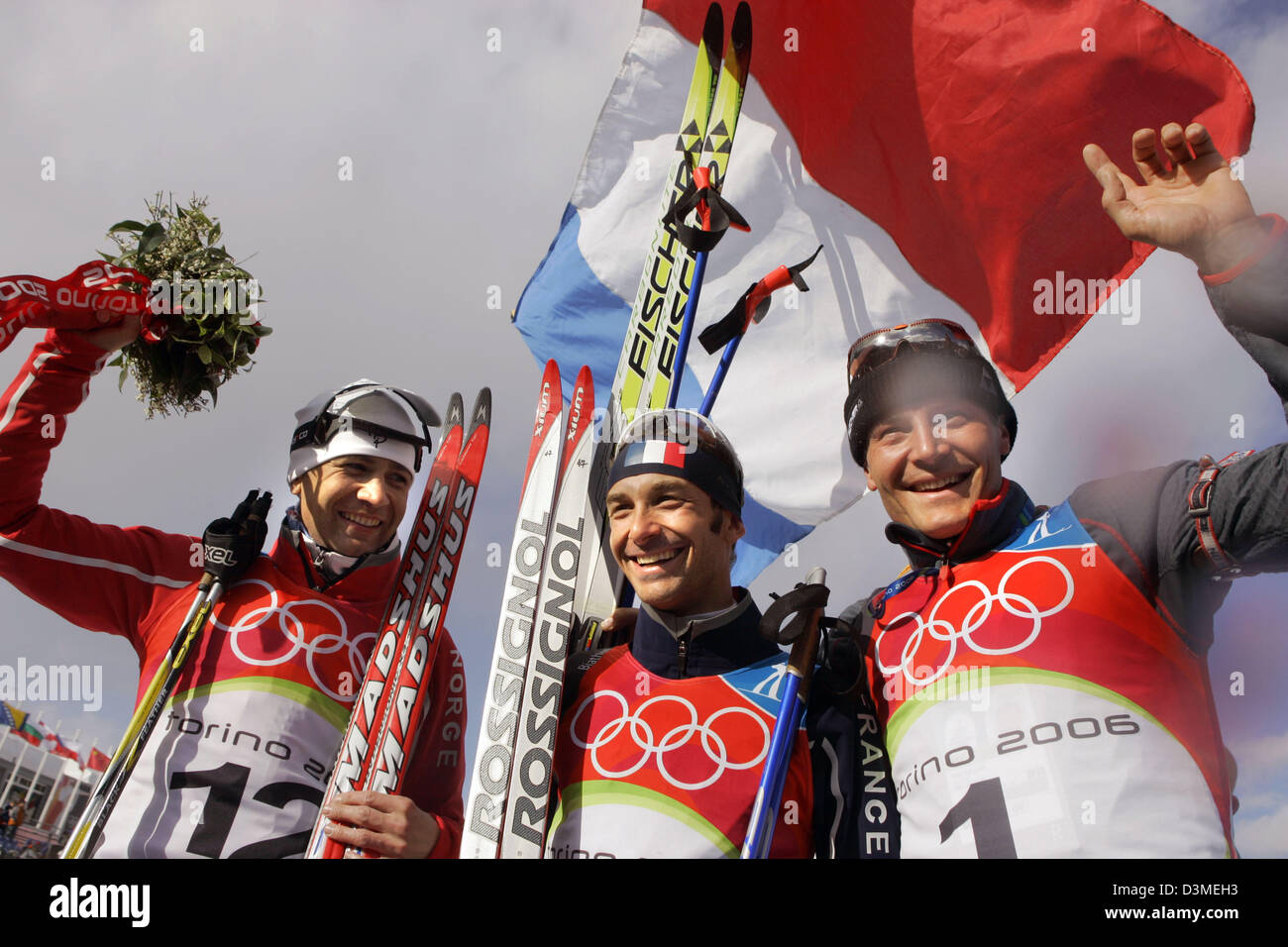 (dpa) - (L-R) Silver medalist Ole Einar Bjoerndalen of Norway, Gold medal winner Vincent Defrasne of France and Bronze medalist Sven Fischer of Germany celebrate on the podium after the men's 12.5km Pursuit Biathlon competition at the Turin 2006 Winter Olympic Games in Cesana, Italy, Saturday 18 February 2006. Photo: Bernd Thissen Stock Photo