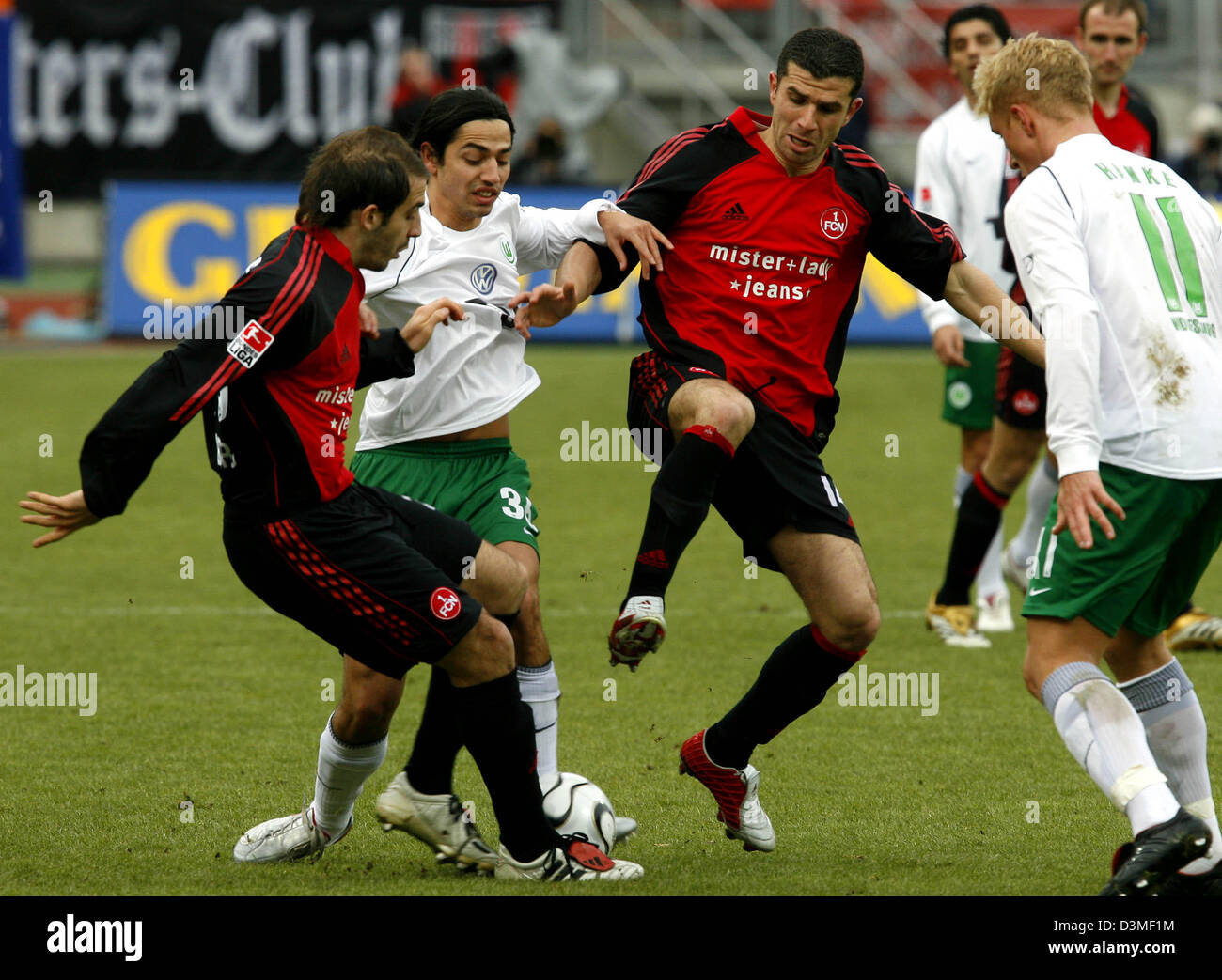 VfL Wolfsburg's Jahouar Mnari (2nd from L) and Mike Hanke (R) fight with 1.FC Nuremberg's Javier Horacio Pinola (L) and Adel Chedli (C) fight for the ball during the Bundesliga match at the Franken stadium in Nuremberg, Germany, Saturday, 18 February 2006. Photo: Daniel Karmann Stock Photo