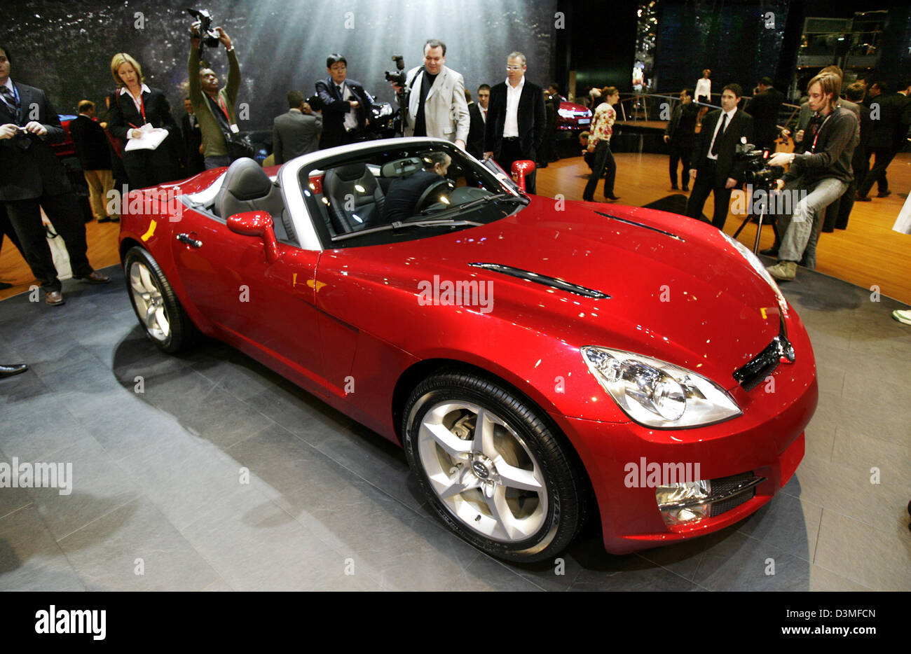 Journalists inspect the new Opel GT at the 76th International Motor Show  and Accessories in Geneva, Switzerland, Tuesday, 28 February 2006. The  famous motor fair opens its doors for public visitors from