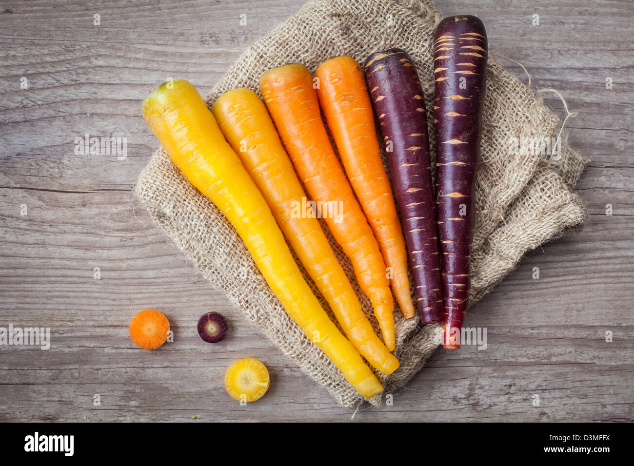 Assortment of fresh carrots on wooden background Stock Photo