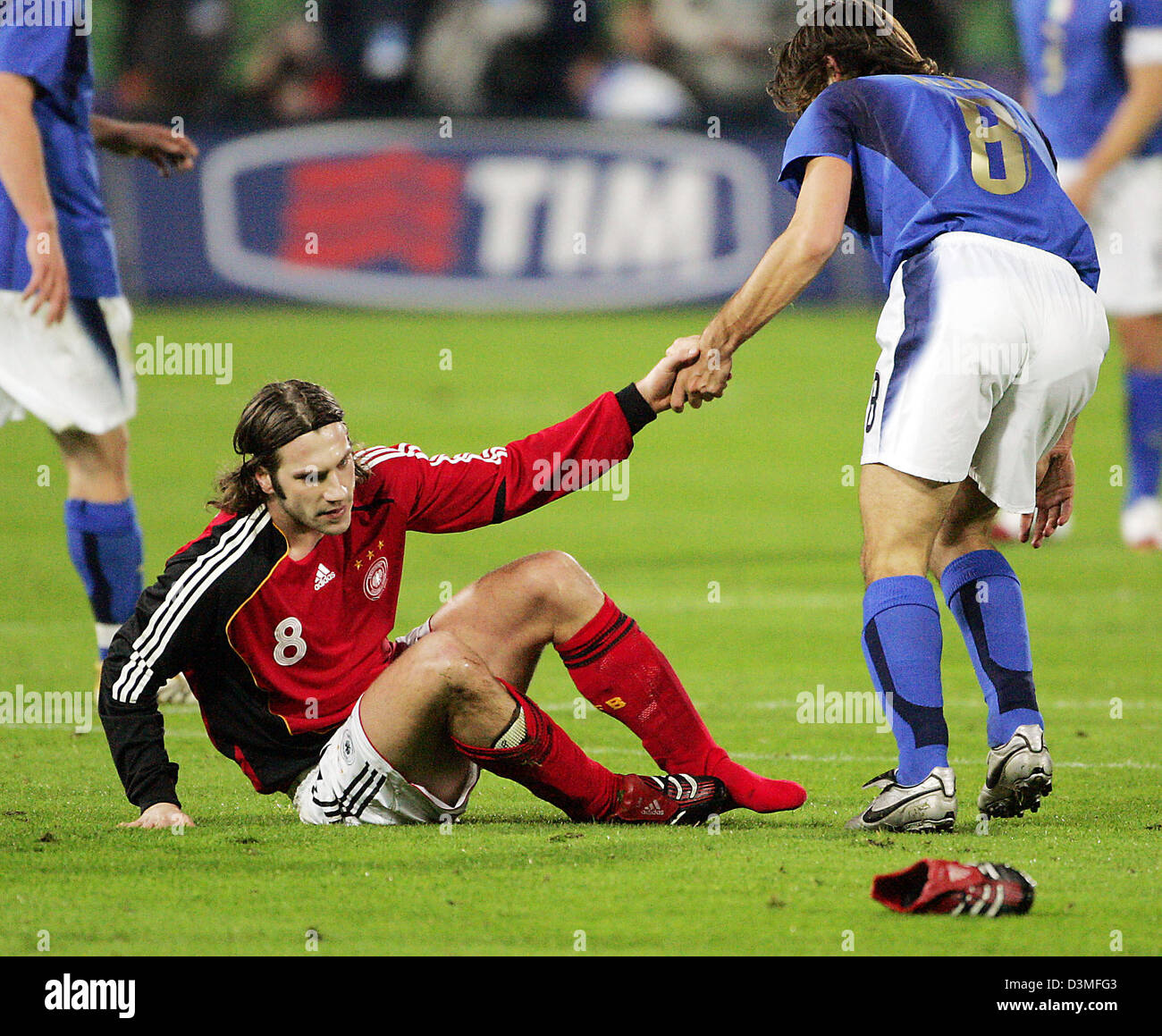 Italy's Andrea Pirlo (R) helps German national soccer player Torsten Frings back on his feet during the international friendly in Florence, Italy, Wednesday, 01 March 2006. Italy thumped World Cup hosts Germany 4-1 in a surprisingly one-sided match. Two goals in the first seven minutes from Gilardino and Toni put the Italians in control. De Rossi's header made it three and Del Pier Stock Photo