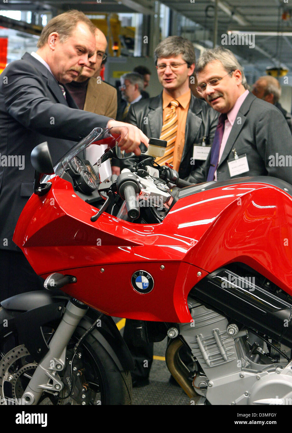 Guests admire a new F800S motorbike during a festivity on the occasion of  the inauguration of the production of a new BMW motorbike line in Berlin,  Thursday 02 March 2006. Last year