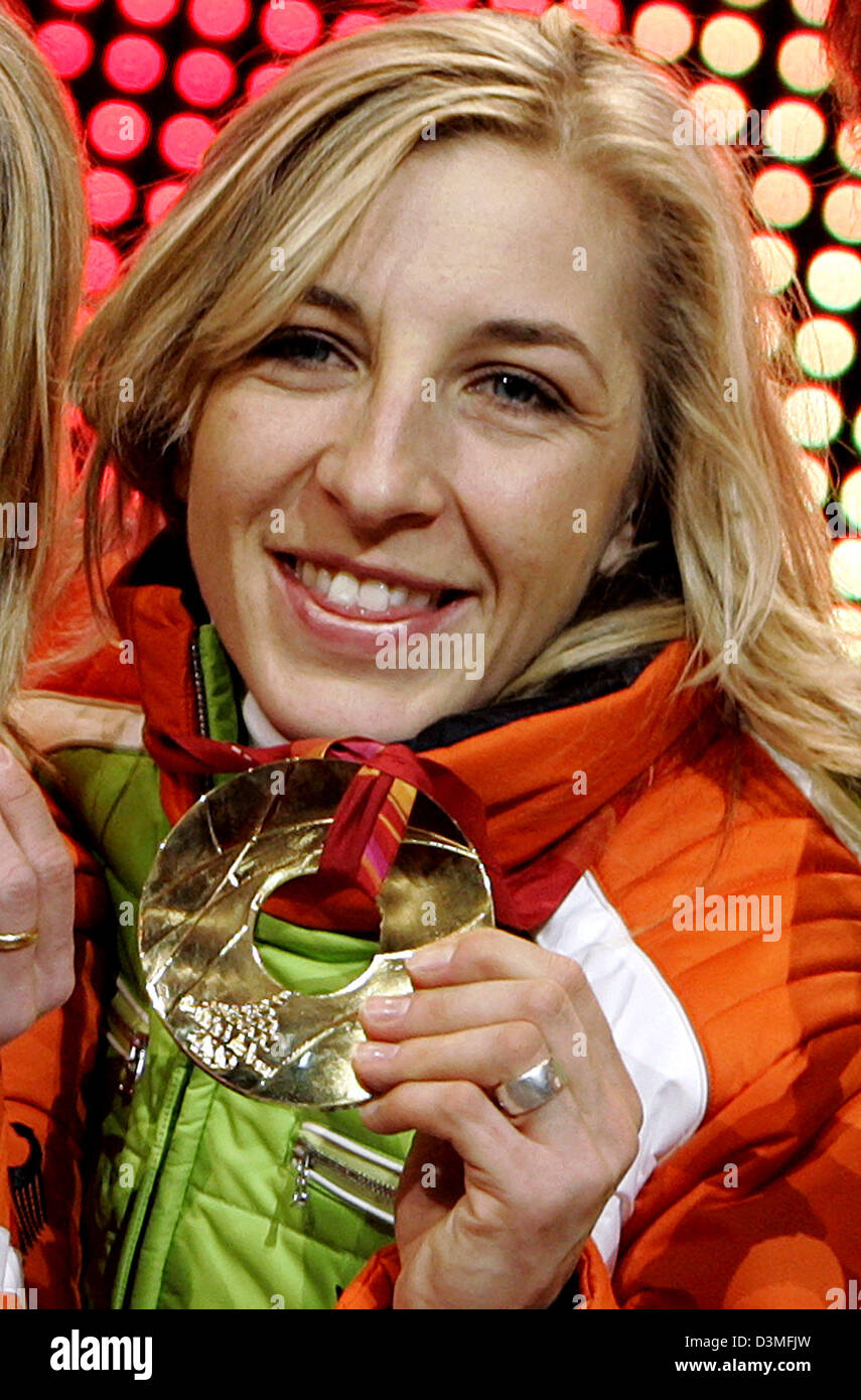 German speed skater Anni Friesinger presents her gold medal during the