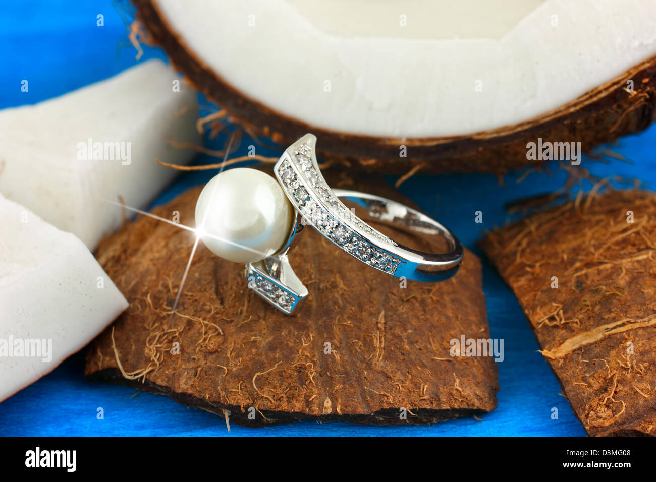 Ring with pearl and diamonds on coconut, jewelry concept Stock Photo