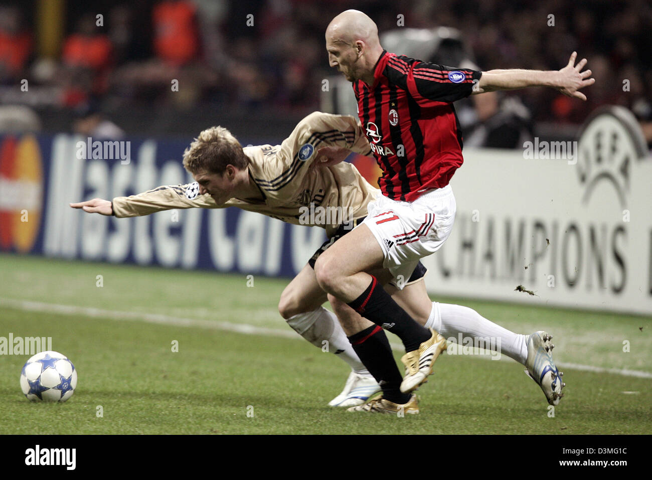 AC Milan's Jaap Stam (R) and FC Bayern Munich's Bastian Schweinsteiger  fight for the ball during the UEFA Champions League round of last 16 clash  at the Giuseppe-Meazza stadium in Milan, Italy,, image size:1300x957