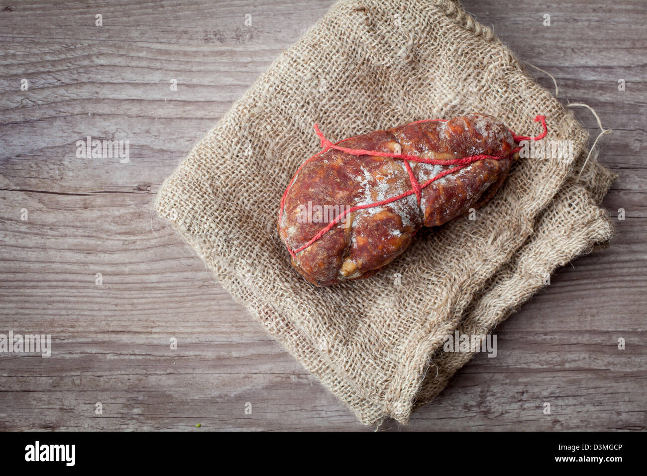 Tasty italian Soppressata ham on wooden background Stock Photo Alamy