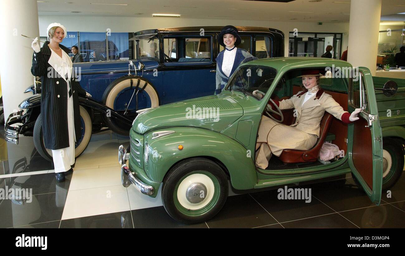 Three models pose in front of a  Fiat Topolino dating 1949 (F) and a Cadillac 341A Imperial Sedan dating 1828 (B) at the Retro Classics oldtimer show in Stuttgart, Germany, Tuesday, 14 March 2006. The Retro Classics at the Stuttgart exhebition centre Killesberg is an international exchange for classic cars, motorbikes, replacement parts and restoration. Visitors can enjoy heaps of  Stock Photo