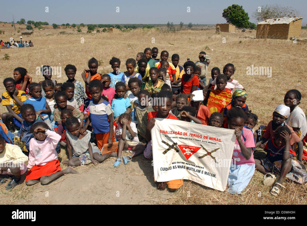 (dpa file) - The picture shows schoolkids holding up a banner that warns of landmines outside the war-ravaged provincial city Caala, Angola, 22 July 2005. Photo: Wolfgang Langenstrassen Stock Photo