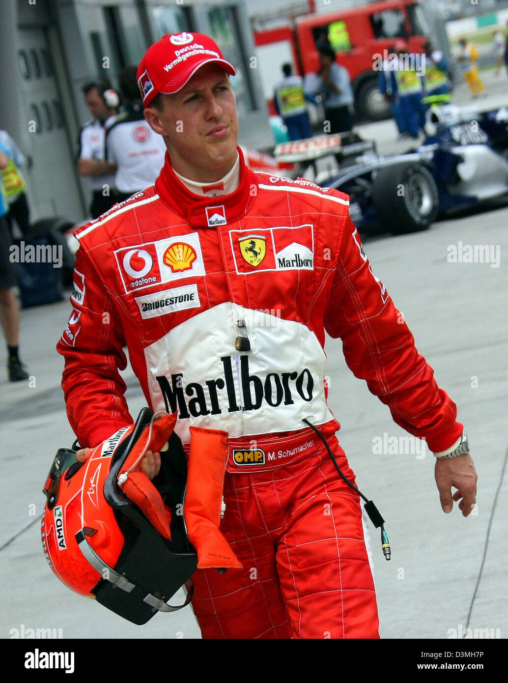 German Formula One driver Michael Schumacher of Ferrari's F1 team walks  through the paddock after the second practice session at the F1 racetrack  in Sepang near Kuala Lumpur, Malaysia, Friday 17 March