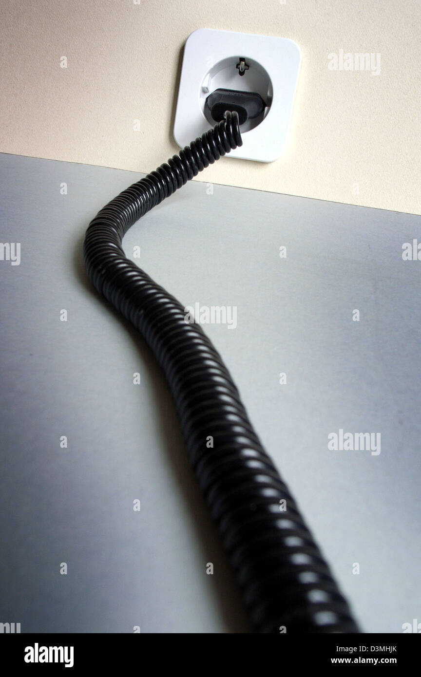 The picture shows a black plug stuck in a white power socket in Frankfurt Main, Germany, 17