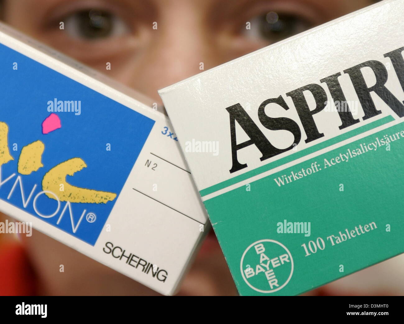 A staff member of a pharmacy shows the packages of Aspirin pain
