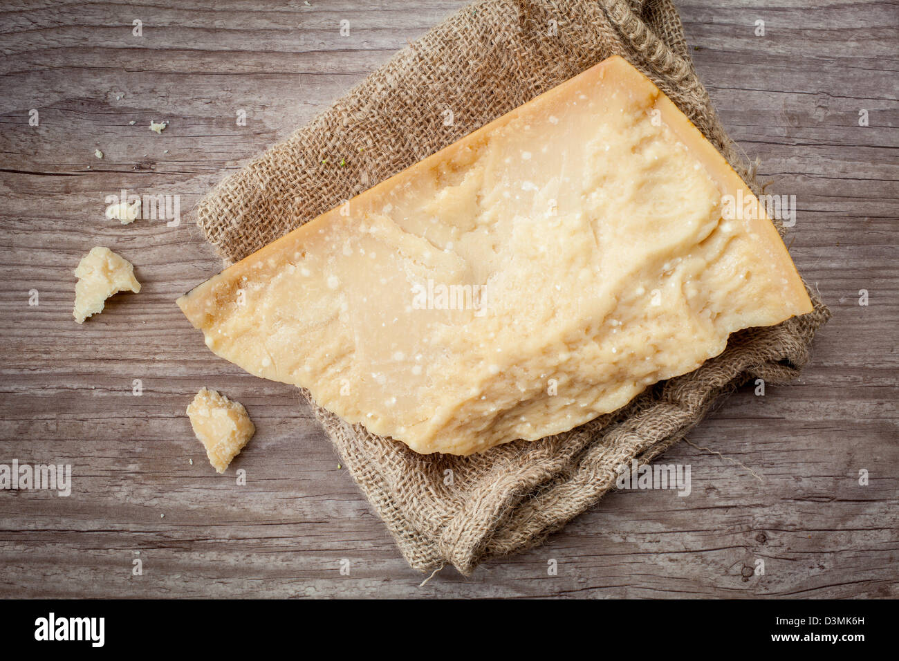 Portion of parmesan cheese on wooden background Stock Photo