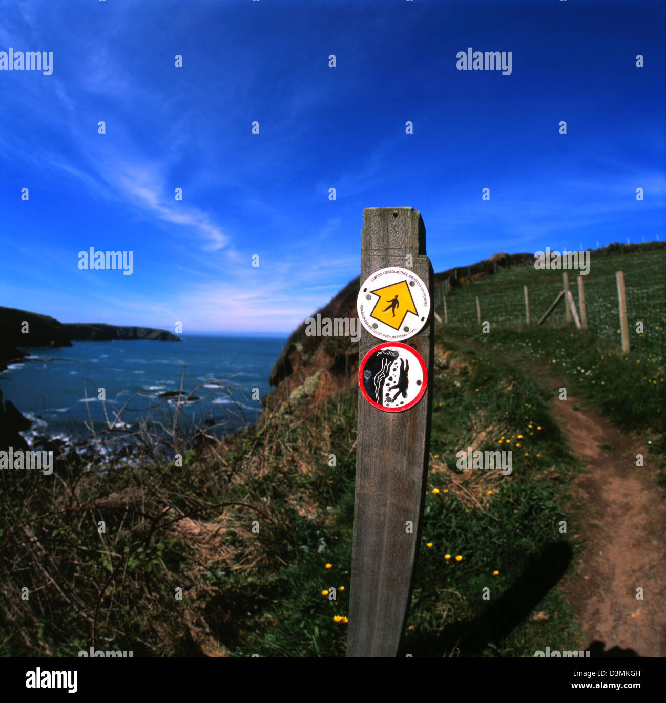 a sign warning of cliffs on the coastal path Stock Photo