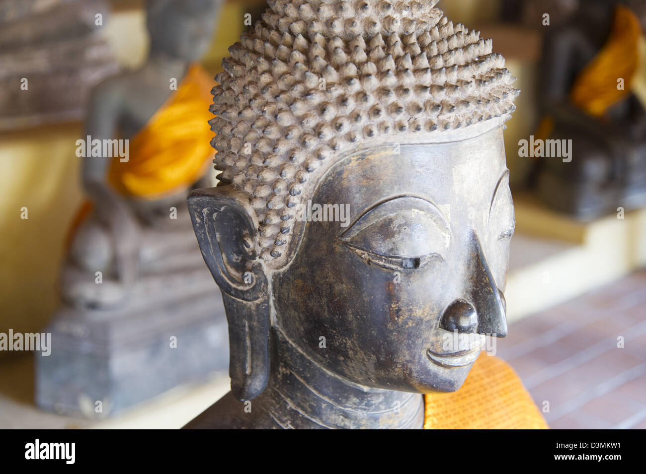 Bronze bust of a Buddha figure with tight hair curls, at Wat Sisaket in  Vientiane, Laos Stock Photo - Alamy