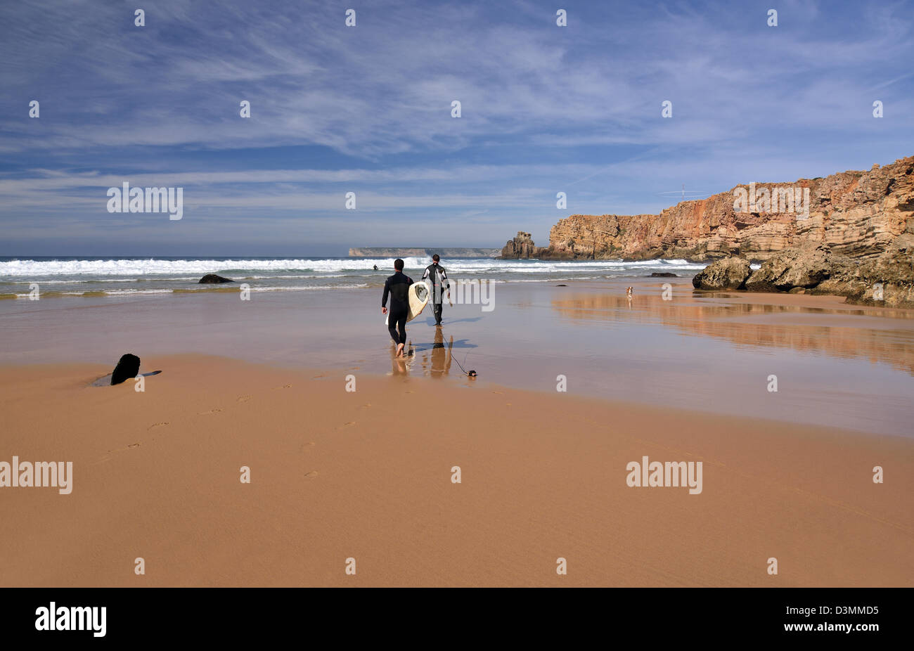 Portugal, Algarve: Surfers with boards entering in the water at beach Praia do Tonel in Sagres Stock Photo