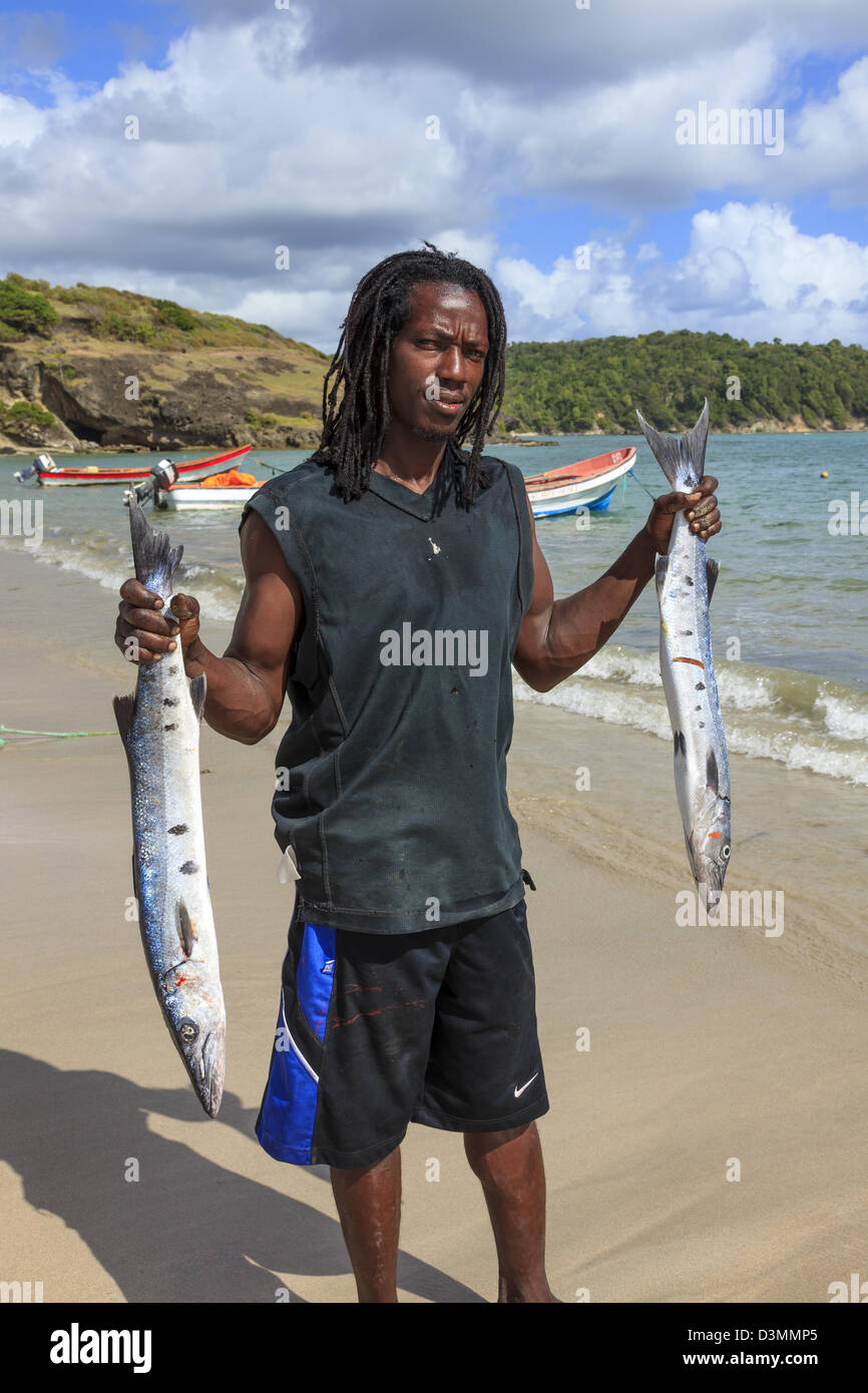 Local fisherman with fish from a fresh catch at Savannes Bay, St Lucia Stock Photo