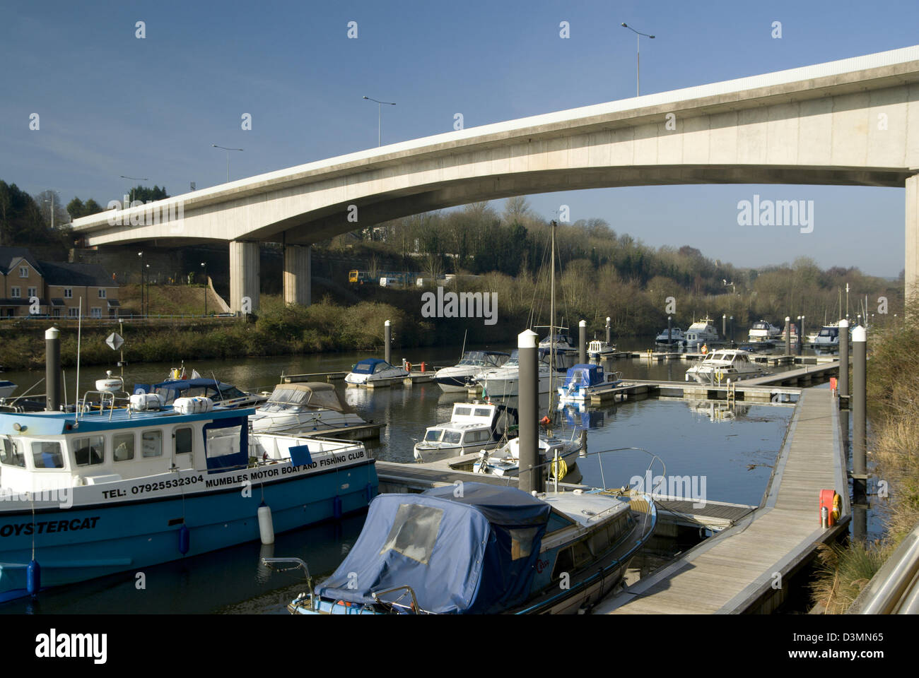 boats moored on lower ely river with road bridge above penarth vale of glamorgan south wales uk Stock Photo