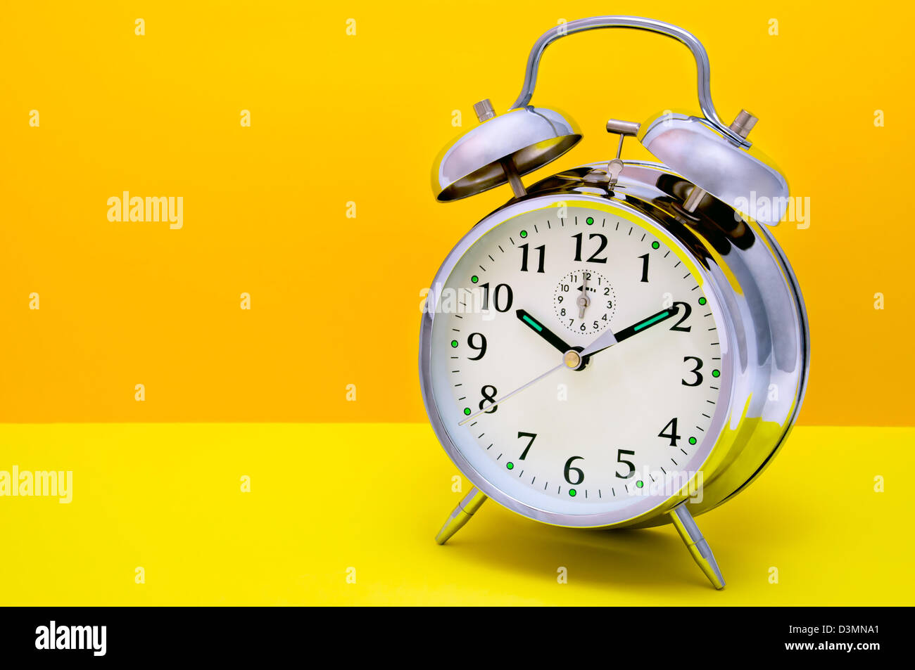 Retro bell alarm clock time metal classic yellow Stock Photo Alamy