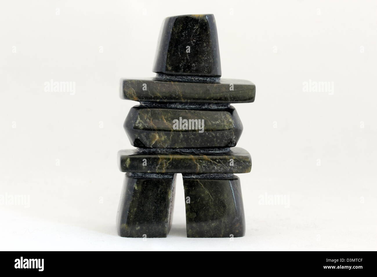An Inuit sculpture of an inukshuk in serpentine, by Tommy Saila, Cape Dorset community. Stock Photo