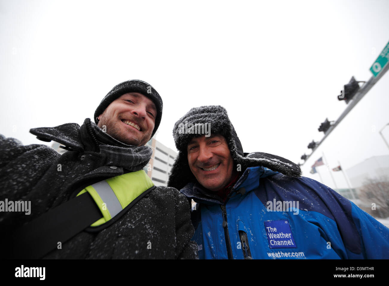 Lincoln, Nebraska, USA. 21st February 2013. Jim Cantore (right) poses for a photograph in Lincoln, Nebraska between breaks reporting on a winter storm. Credit:  LorenRyePhoto / Alamy Live News Stock Photo