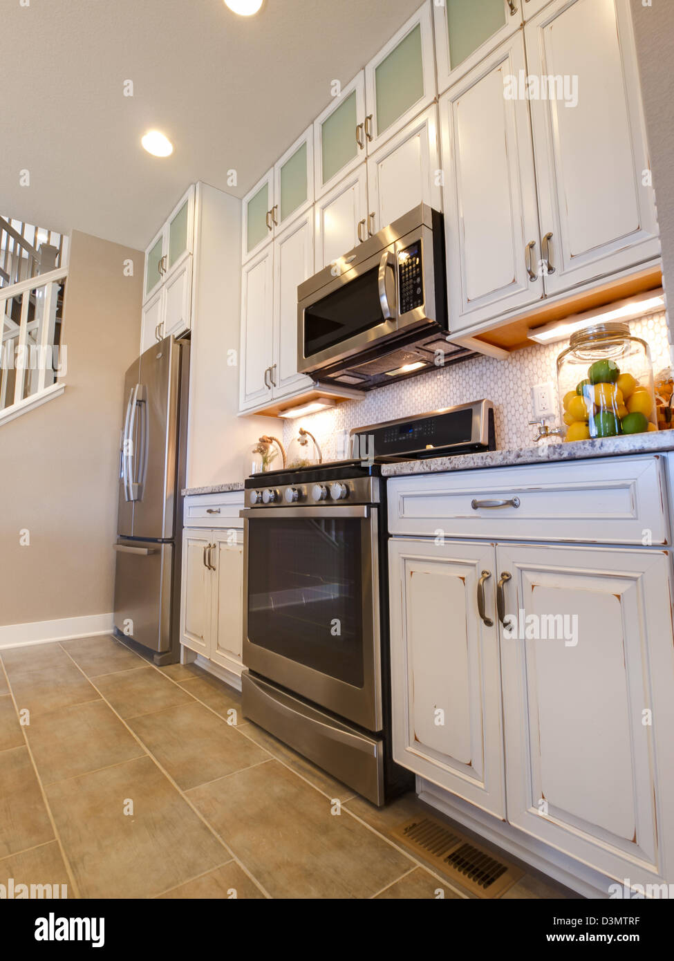 Modern kitchen with white cabinets and stainless appliances Stock Photo ...