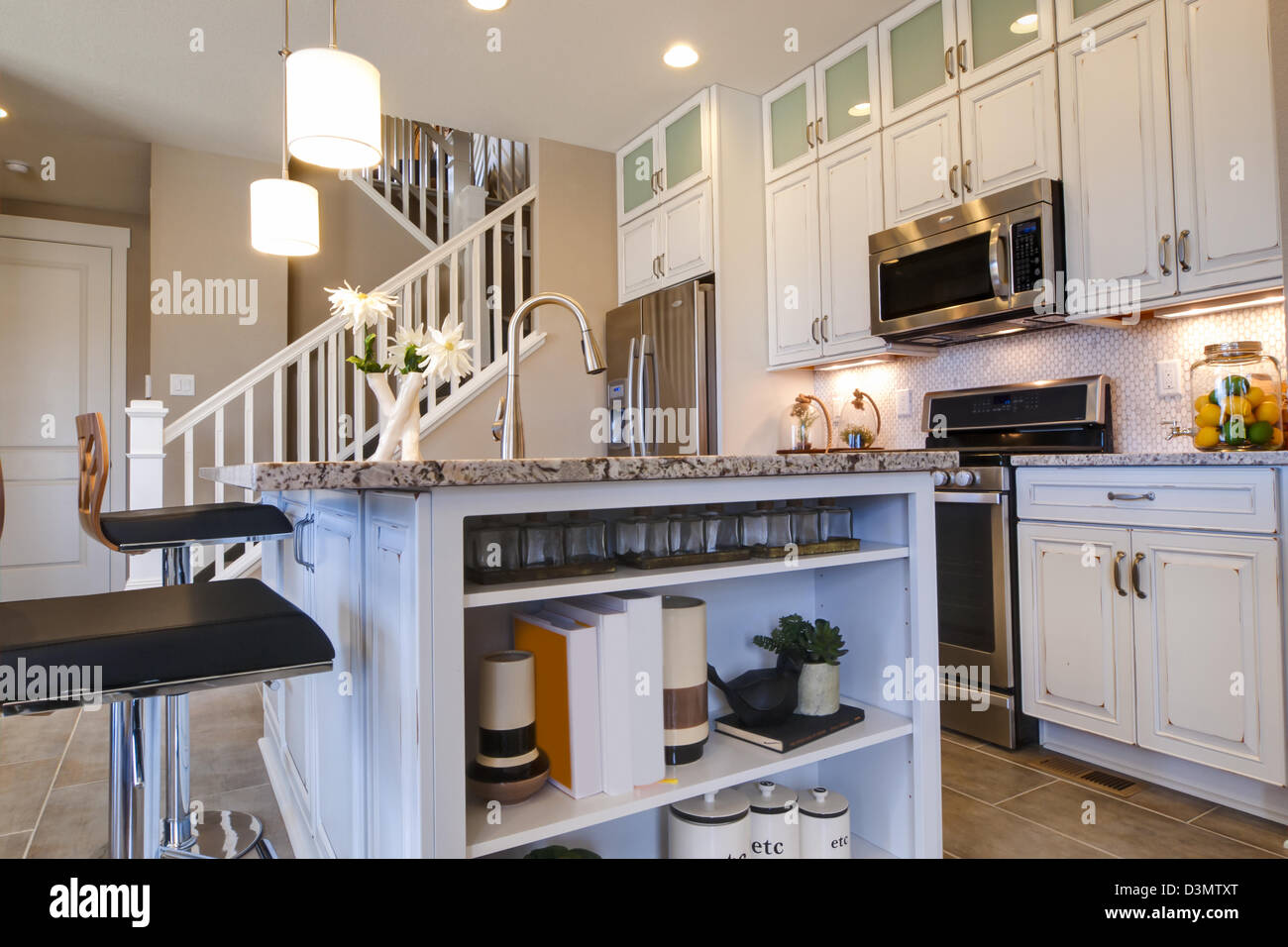 Modern kitchen with white cabinets and stainless appliances Stock Photo ...