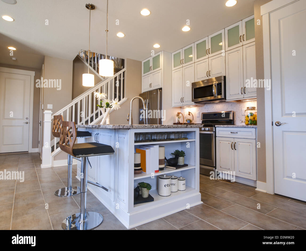 Modern kitchen with white cabinets and stainless appliances Stock Photo ...