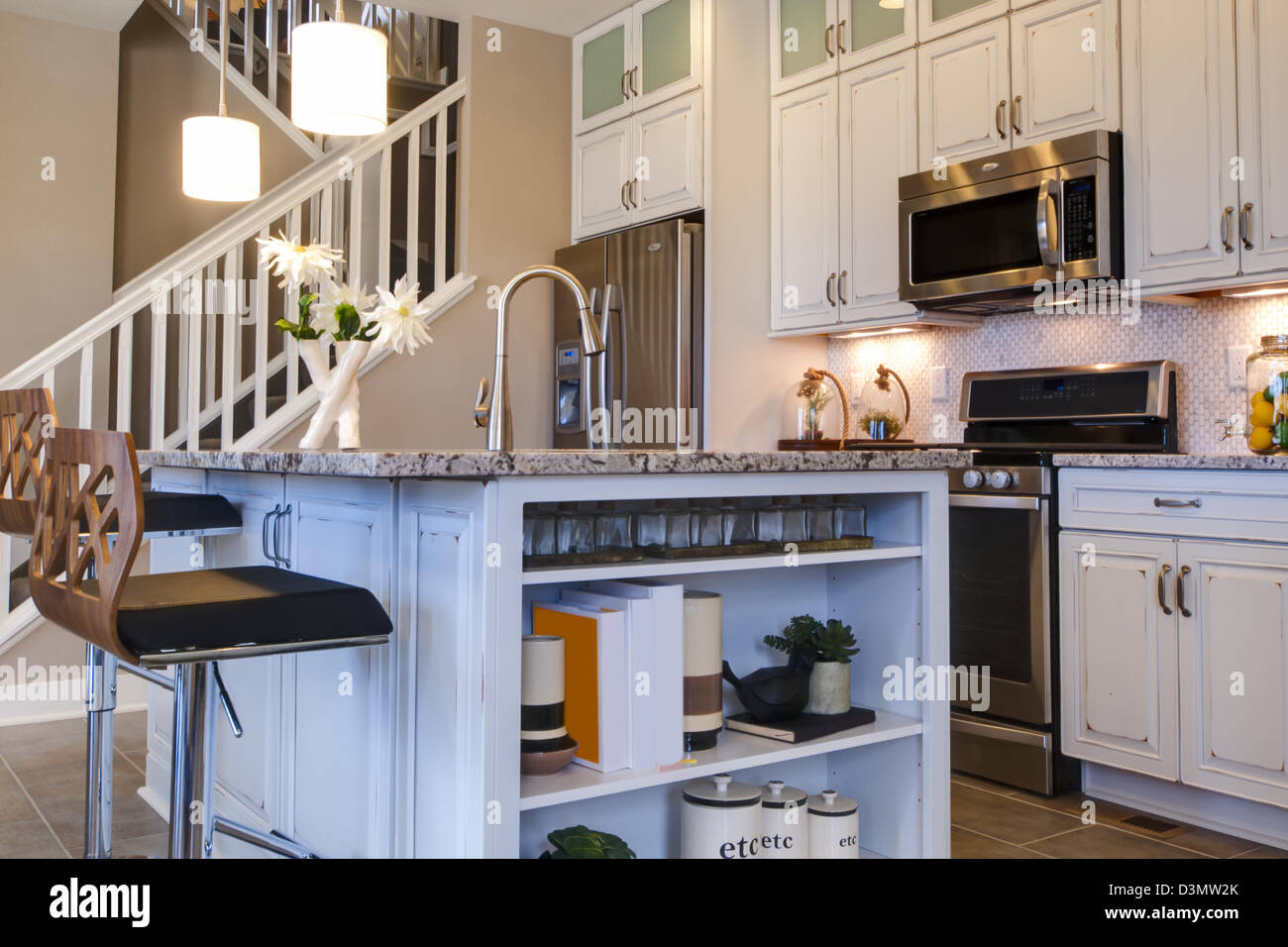 Modern kitchen with white cabinets and stainless appliances Stock Photo ...
