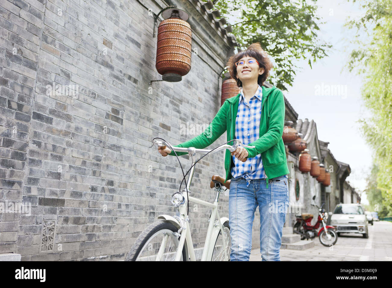 Smiling Young Asian Chinese Woman in Bicycle, Beijing, China Stock Photo