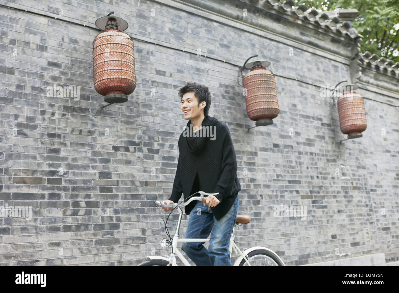 Smiling Young Asian Chinese Man in Bicycle, Beijing, China Stock Photo
