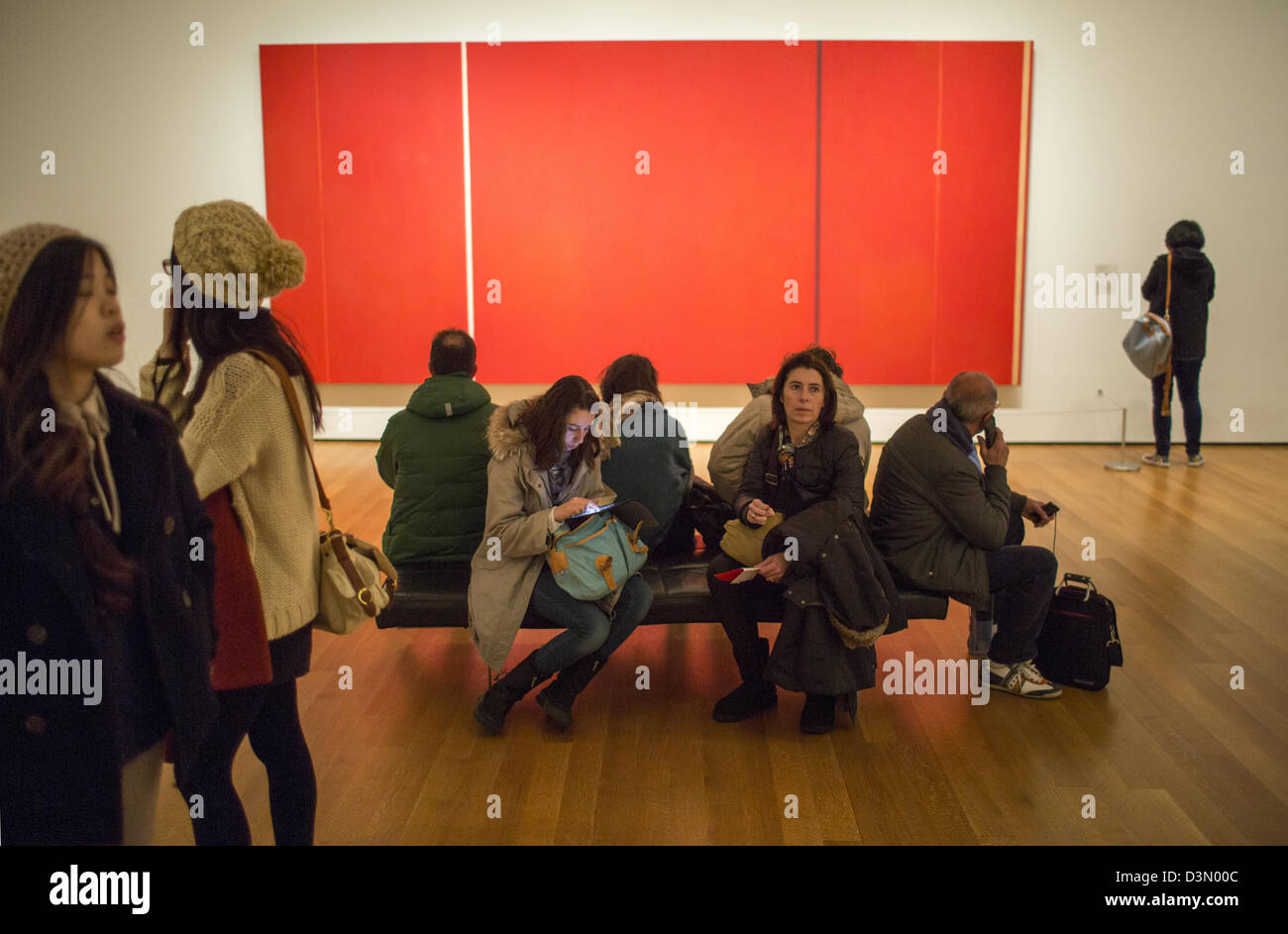 Viewers walk through a gallery of modern art paintings at the Museum of