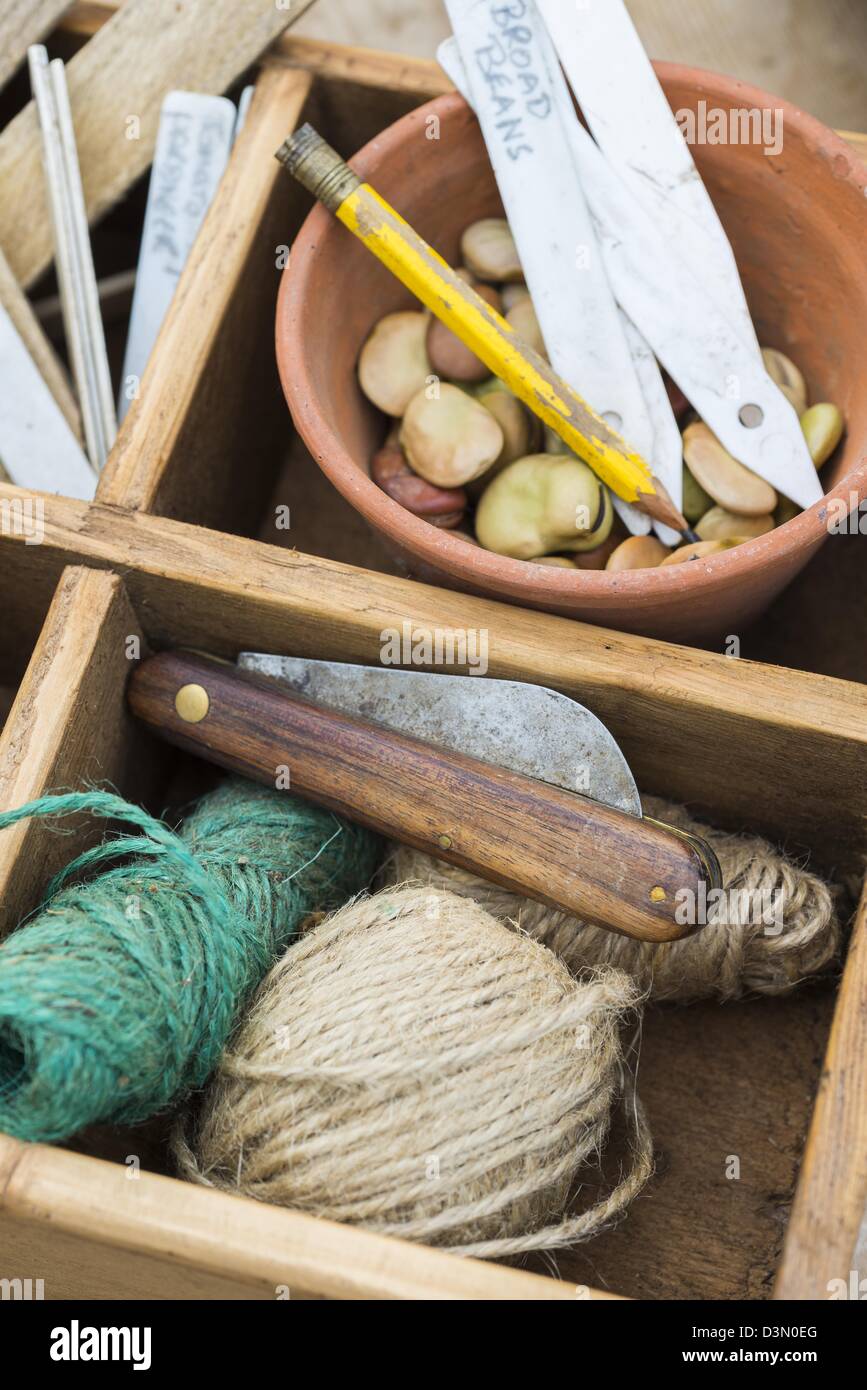 Potting bench springtime still life with saved seeds and gardening items Stock Photo