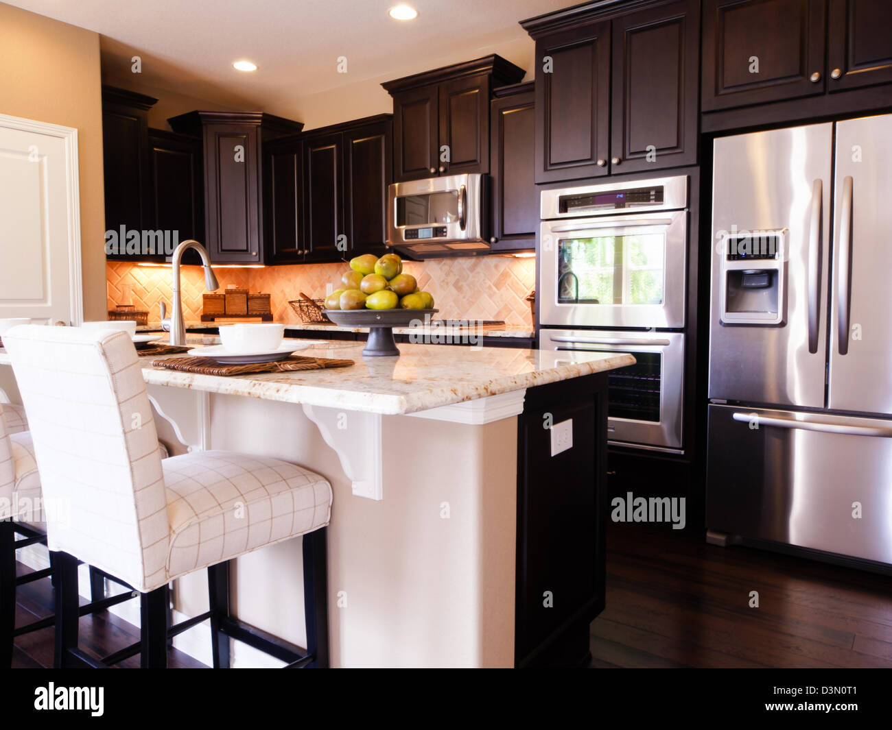 Modern kitchen with dark wood cabinets and hardwood floors Stock Photo ...