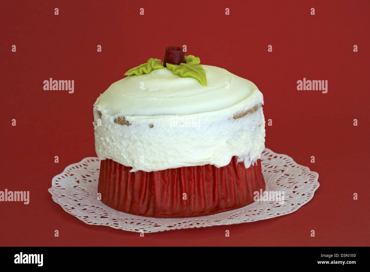 Be Mine Giant Vanilla Cupcake on doily set on red background - ideal for Valentines day, Valentine day Stock Photo