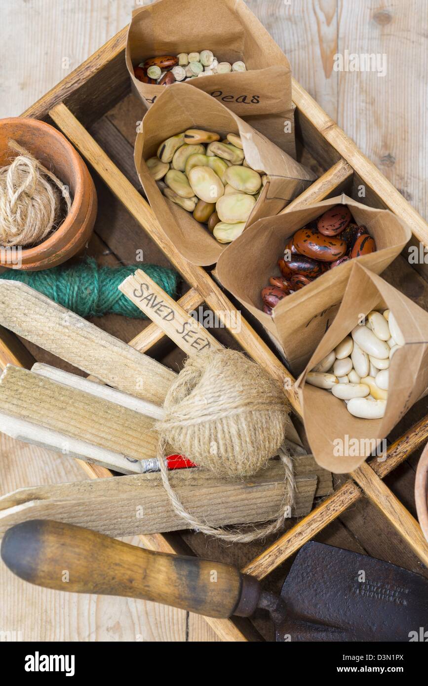 Potting bench springtime still life with saved seeds in homemade packets and gardening items Stock Photo