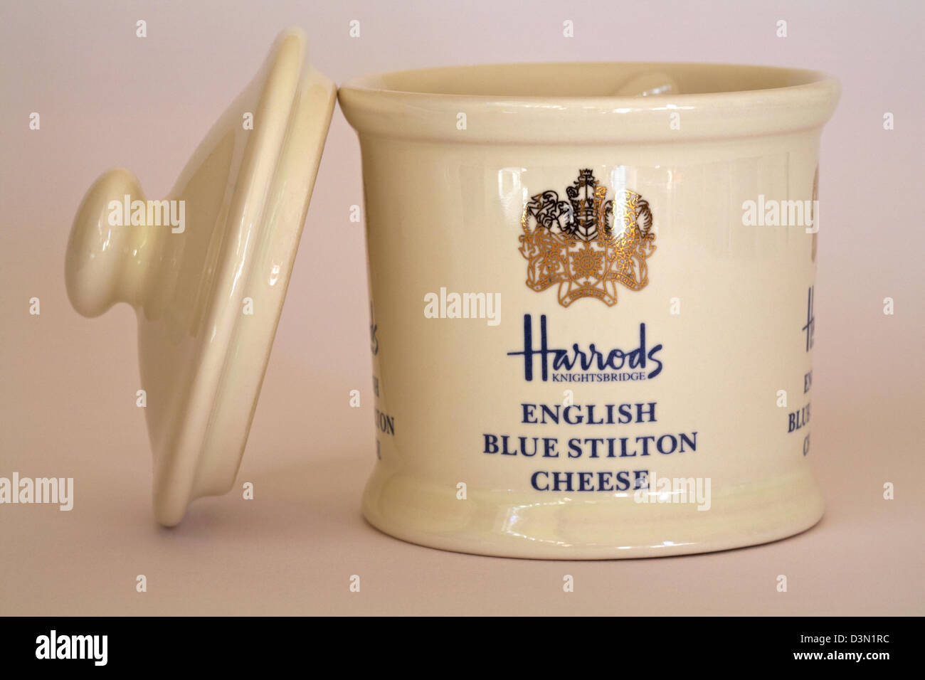 pot for Harrods Knightsbridge English blue Stilton cheese with lid off and resting by side isolated on white background Stock Photo