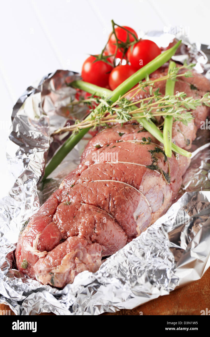 Stuffed meat roulade in tinfoil Stock Photo