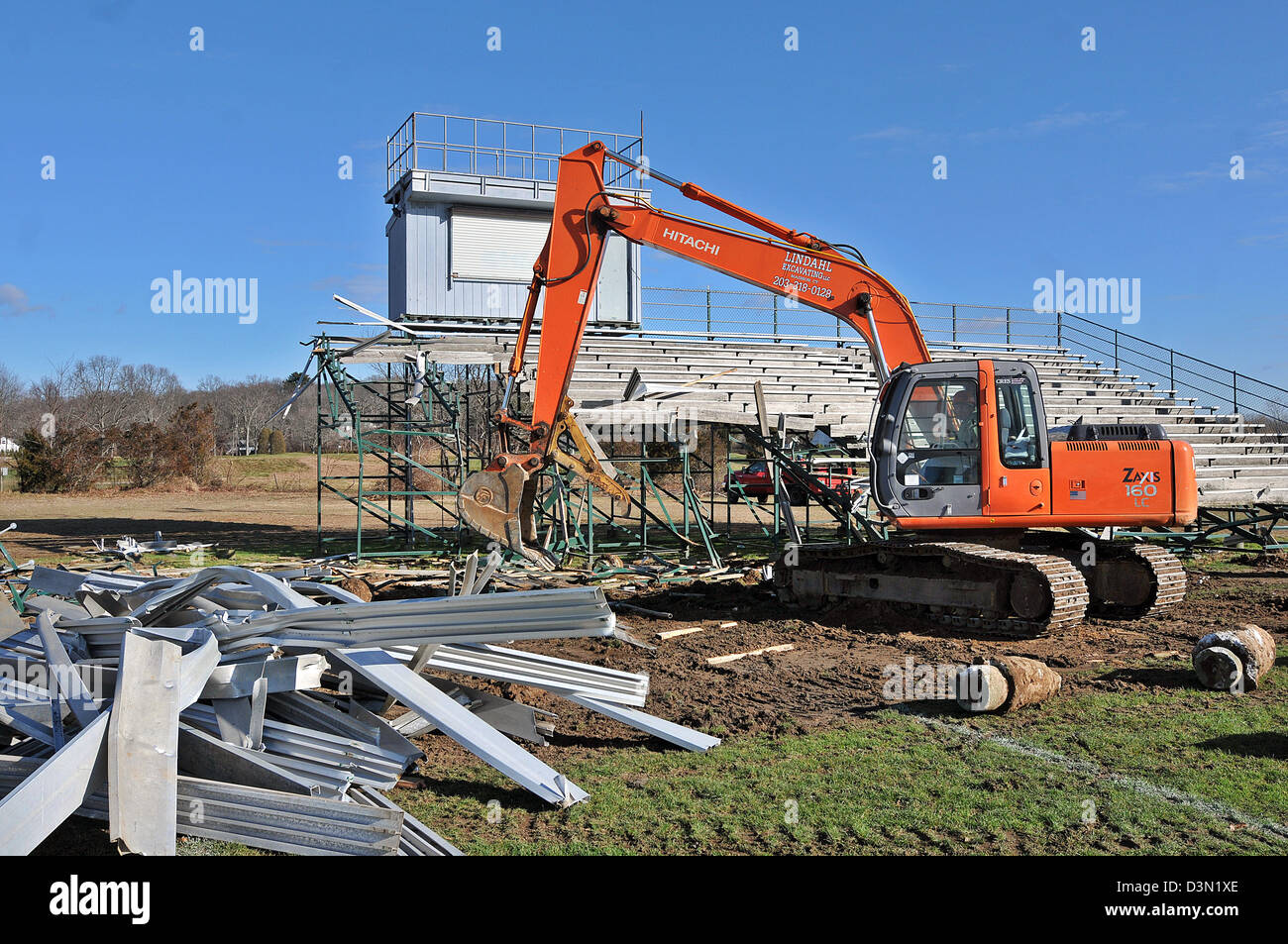A Wrecker Tears Down The Bleachers At A Football Stadium In Madison CT A Wrecker Tears Down The Bleachers At A Football Stadium In Madison CT