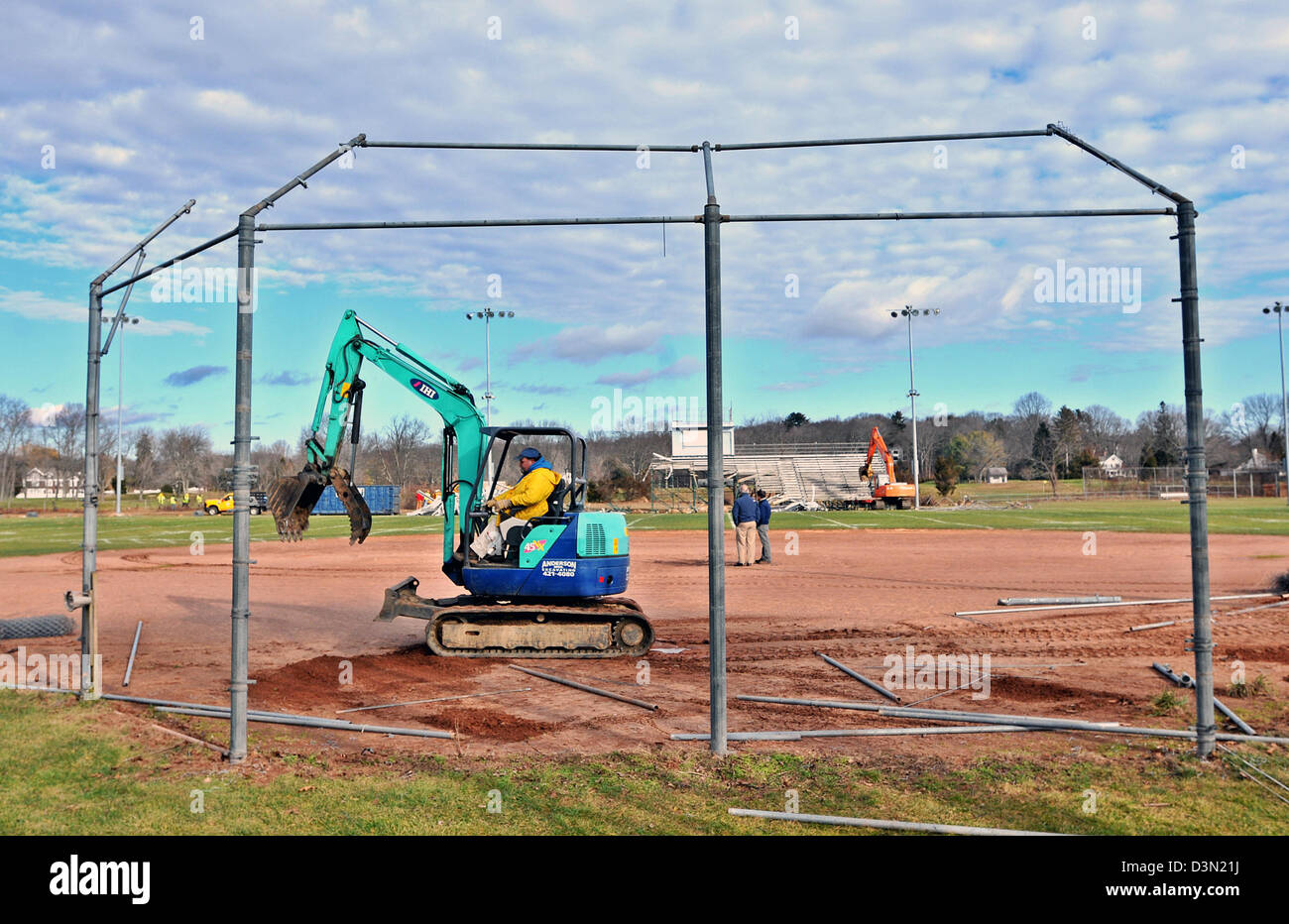 A wrecker tears down the bleachers at a baseball stadium in Madison CT USA as the town prepares to build a new one. Stock Photo
