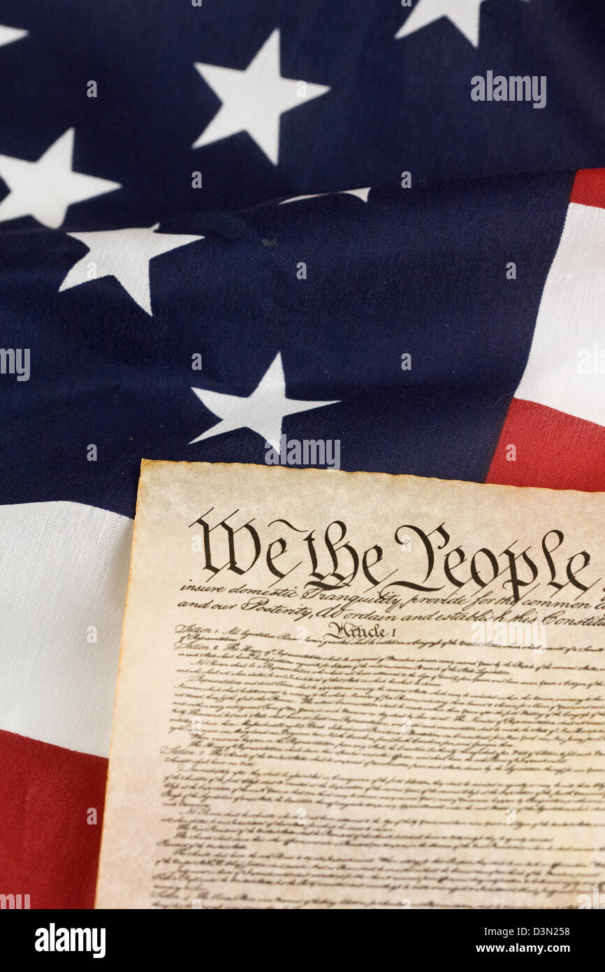 US Constitution against an american flag. Stock Photo
