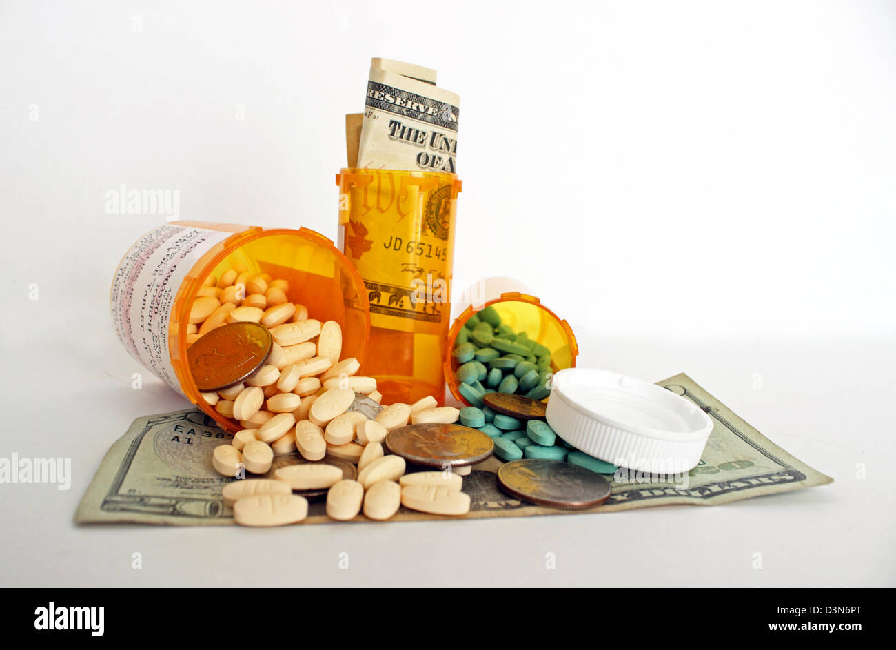 A photograph of prescription medicine bottles, pills and money representing the high cost of healthcare on a white background. Stock Photo