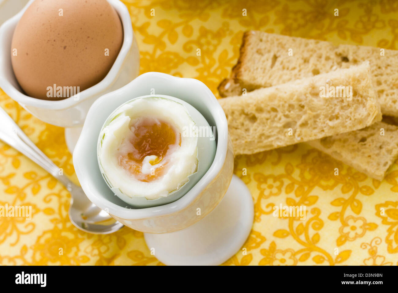 Soft boiled egg in egg cup and served with toast fingers Stock Photo