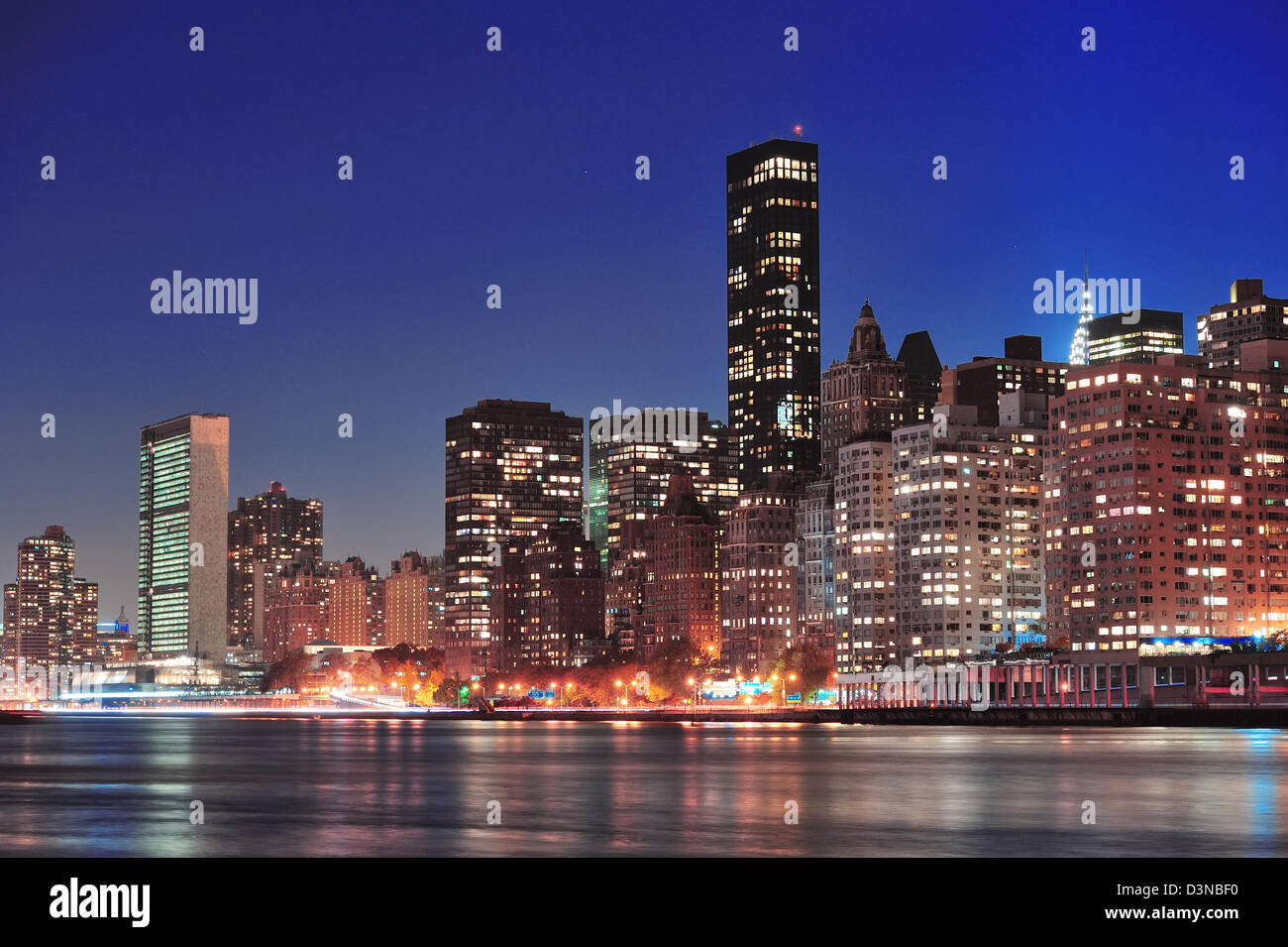 New York City Manhattan midtown skyline at night over East River Stock ...