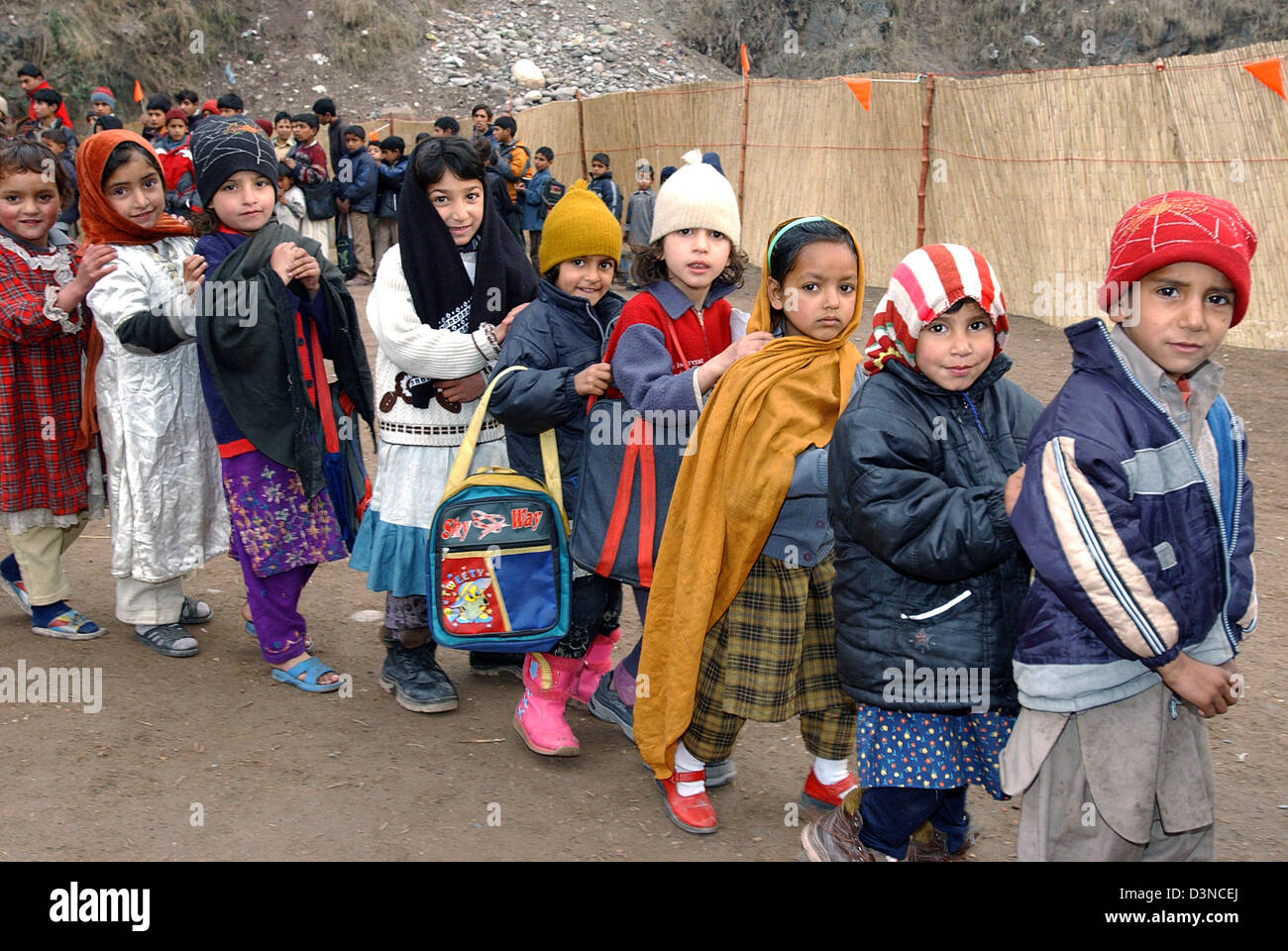 Schoolchildren queue ready for school in a refugee camp  near the town of Muzaffarabad, Pakistan, Tuesday, 31 January 2006. Millions of people suffered in the aftermath of an earthquake which struck in October 2005 hitting the province of Kashmir. Photo: Wolfgang Langenstrassen Stock Photo