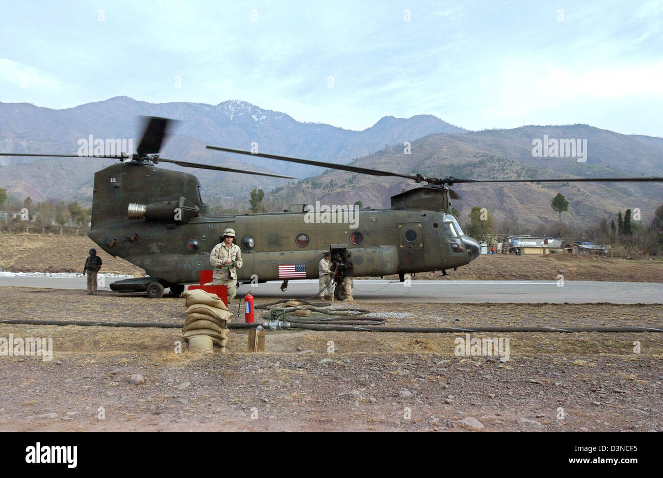 A US chinook helicopter is on stand-by waiting to be loaded with aid supplies near Muzaffarabad in Pakistan, Monday, 30 January 2006. Millions of people suffered in the aftermath of an earthquake which struck in October 2005 hitting the province of Kashmir. Photo: Wolfgang Langenstrassen Stock Photo