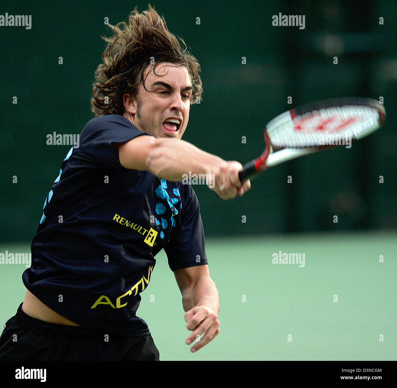 Spanish Formula One driver Fernando Alonso of Renault's F1 team plays tennis  during a charity tournament of F1 drivers and tennis players prior to the  Formula One Grand Prix of Australia in